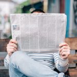 Person reading a newspaper